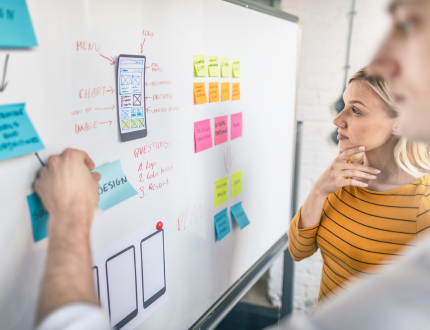 Support, product, and UX teams reviewing a dashboard of top ticket drivers and user journeys